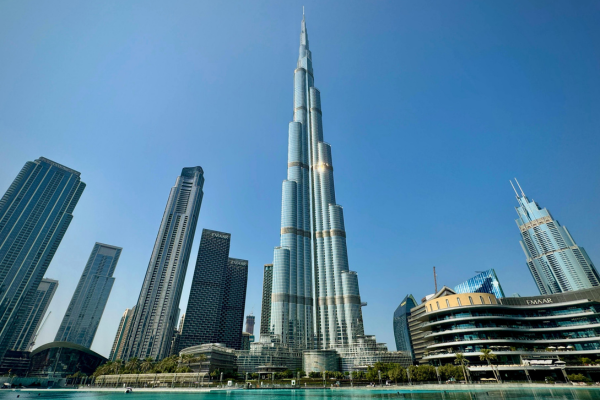 Burj Khalifa skyscraper in downtown Dubai surrounded by luxury towers and waterfront architecture on a sunny day